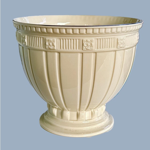 Classic Lenox Forum pedestal bowl in signature ivory porcelain with crisp vertical fluting and a raised decorative band...
