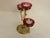 This Hollywood regency candleabra holds 3 small red cups for tea lights. It is am impressive piece as it stands out in...