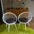 Pair of scandinavian lounge chairs featuring an ellipsoid-shaped backrest /armrest combination , the chairs stand...