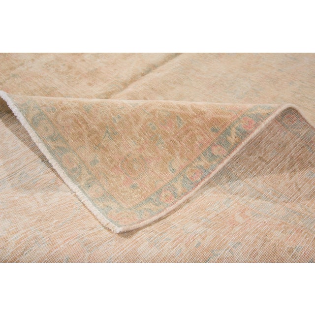 Beautiful Vintage kerman rug. This piece has a peach field with a central medallion design. This rug measures 6'2" x 9'5".