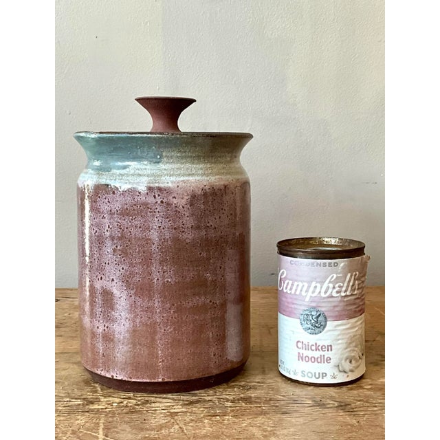 This distinctive lidded jar is a testament to the dynamic glazes and tactile beauty of Mid-Century studio ceramics. Hand-...