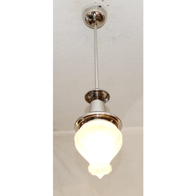 Art Deco pendant lamp, circa 1920. Copper body, newly nickel-plated. Original frosted glass shade. The lamp has been...