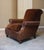 This chair features rolled arms and headrest, turned front legs, and a deep seat and high back. It’s a great place to get...
