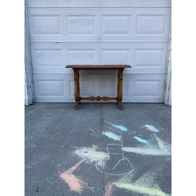 We have a beautiful vintage Renaissance Revival marble top console table for sale. It features an ornate carved wood base...