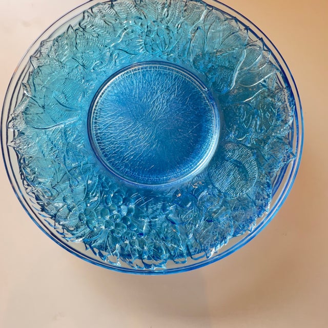 Elegant vintage pressed glass serving plates, in a gorgeous sky-blue colorway; featuring a decorative botanical motif with...