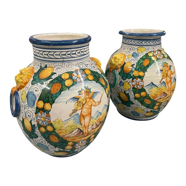 A Pair of Vintage Italianate Majolica Ceramic Urns With Putti & Lion Ring Handles For Sale
