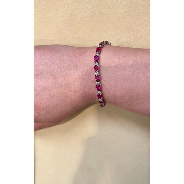 This exceptionally affordable Tennis bracelet has 21 stones of oval Rubies . Each Ruby is spaced by two diamonds . Total...