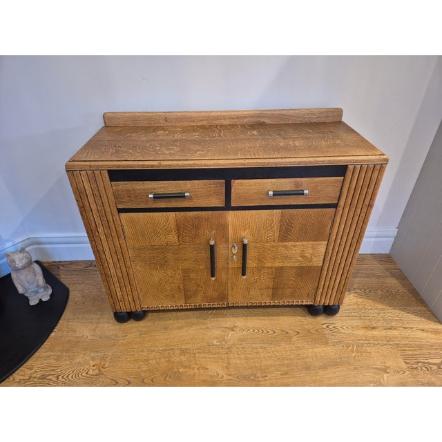 A striking 1930s Art Deco oak sideboard, fully refurbished to celebrate its original character while introducing a bold...