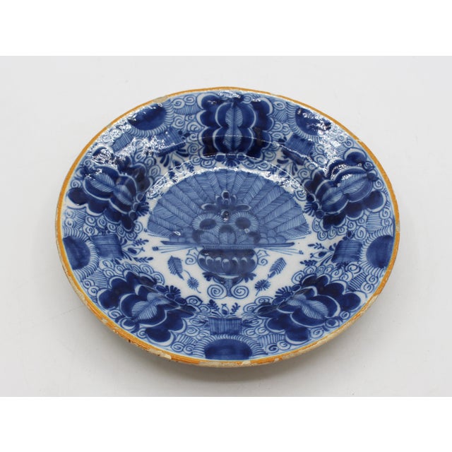 Mid 18th century Delft urn of peacock feathers blue & white plate, Dutch. Ochre rim sets off the design well. A design...