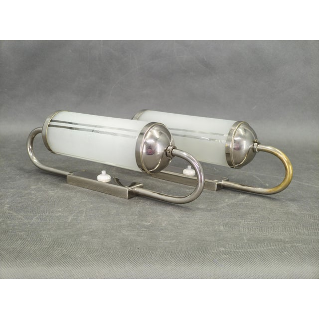 Elegant pair of Art Deco wall lights produced in Czechoslovakia during the 1930s. These refined sconces feature frosted...