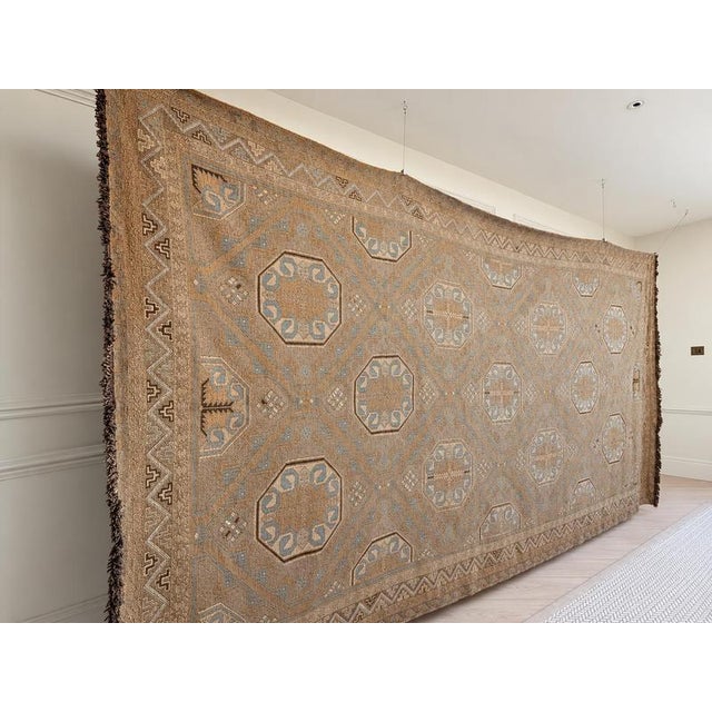 An exceptionally large handwoven Soumak flatweave rug with a beautifully softened palette of powder blue, camel, warm...