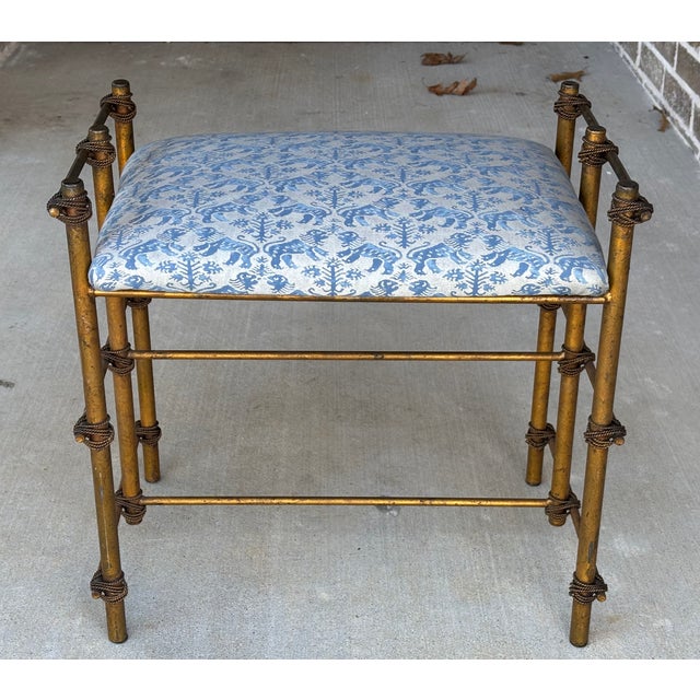 Elegant vanity stool or occasional stool featuring a hand-finished gilt metal frame with cast rope-twist bindings and...