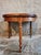 This antique French demi-lune table dates from the early 20th century and is crafted from solid walnut. Designed with a...