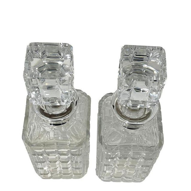 Whiskey decanters with silver collar by Wolfers Frères for Val Saint Lambert Two cut to clear crystal whiskey decanters by...