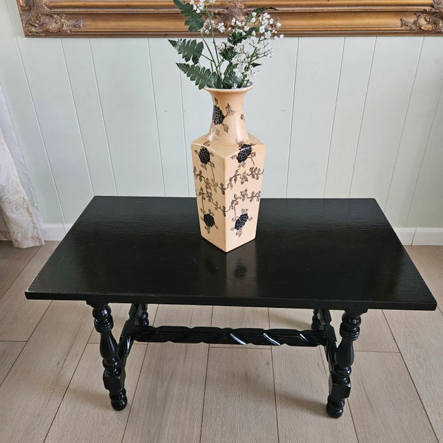 Lovely hand-painted black and bronzy-gold floral & vine pattern on a matte peach glaze. Interior is glossy white....