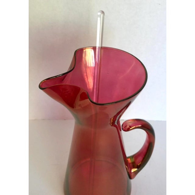 This is a sexy pitcher! It has a great red-pink color and pinched shaped lip. Please note that the handle is slightly...