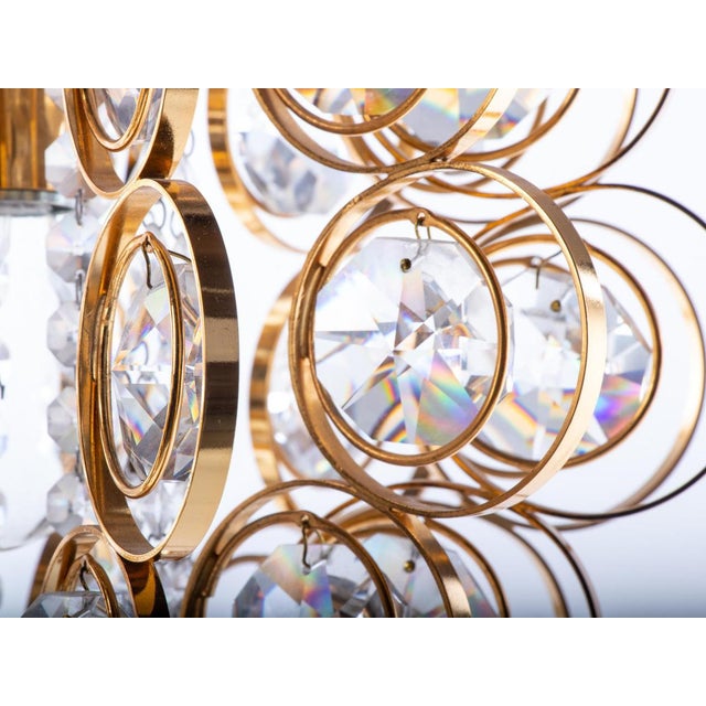 Elegant orbit chandelier with cut swarovski crystals on a gilt-brass frame. The sparkling and glittering palwa chandeliers...