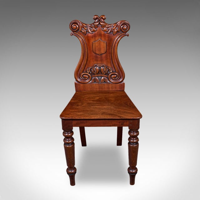 This is an antique hall chair. A Scottish, walnut occasional reception seat, dating to the Victorian period, circa 1860....
