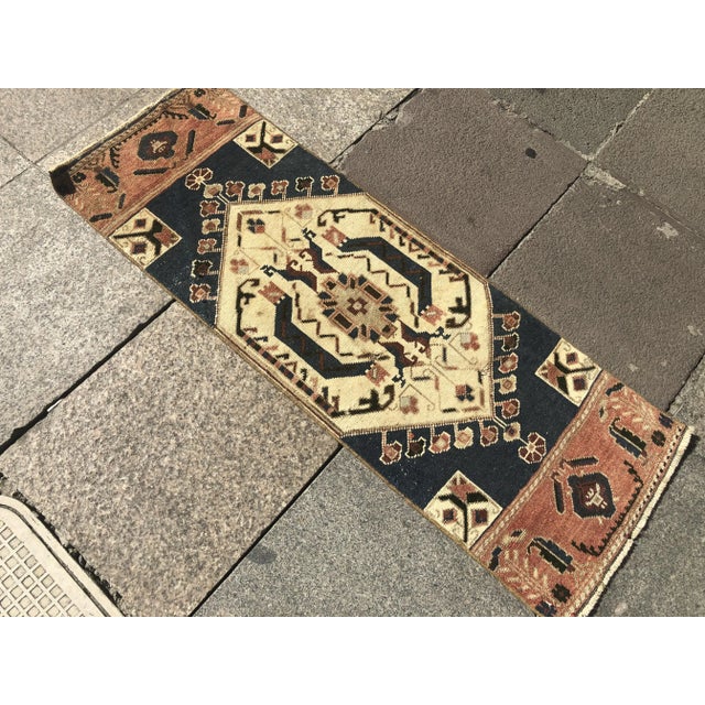 This is a vintage Turkish Oushak rug from the 1960s. The piece was hand-knotted.