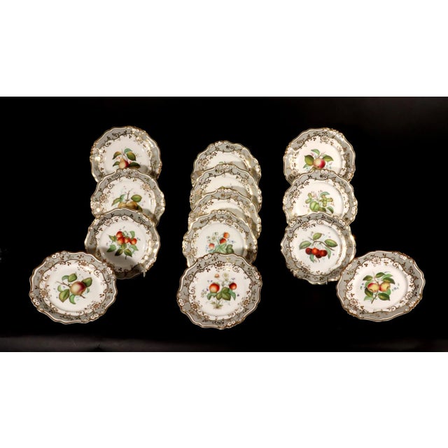 English Porcelain Botanical Fruit Dessert Service, Attributed to Coalport Circa 1830 This eighteen-piece porcelain dessert...