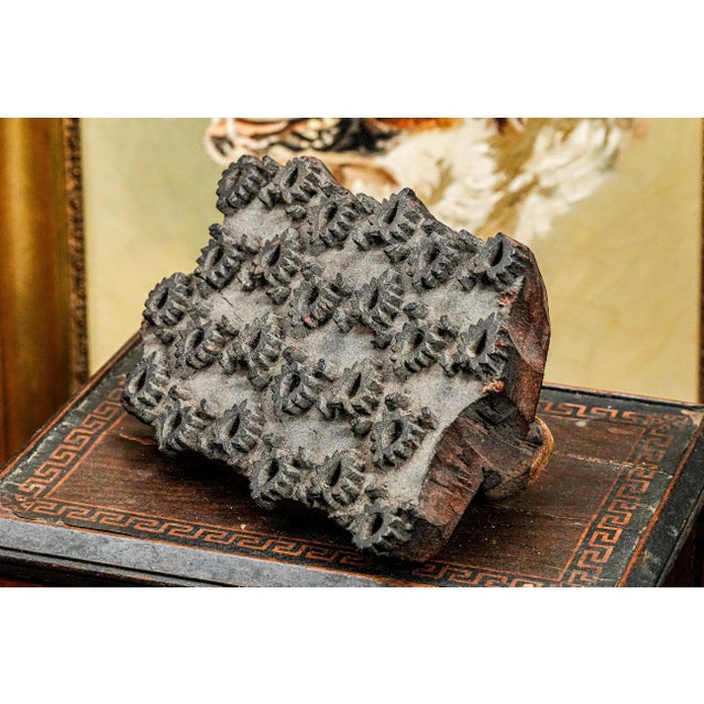 This handmade antique fabric stamper is a richly textured, visually striking piece that speaks to the intricate...
