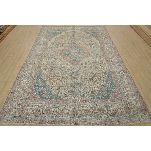 An authentic vintage traditional Tabriz rug hand-knotted with fine wool and natural dyes. This oriental rug features muted...