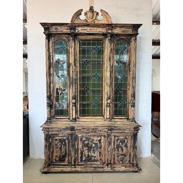 This impressive 18th century Henry II-style cabinet showcases a strong architectural presence, defined by fluted...
