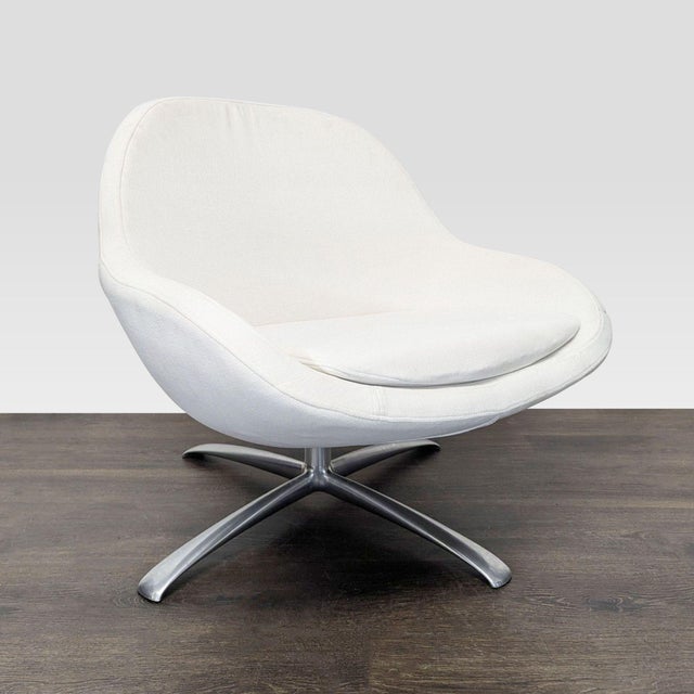 Relax in style with this Bo Concept lounge chair. It features a sleek white fabric seat and a sturdy swivel metal base....