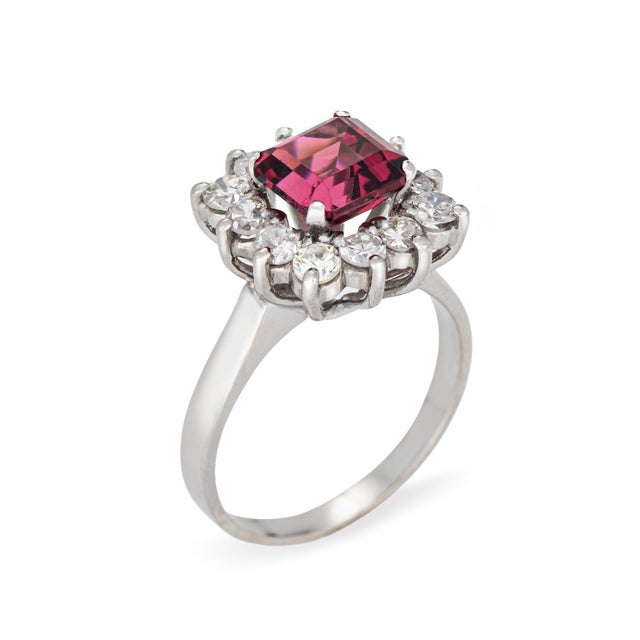 Stylish vintage pink tourmaline cocktail ring (circa 1980s) crafted in 900 platinum. Emerald cut tourmaline measures 7mm...