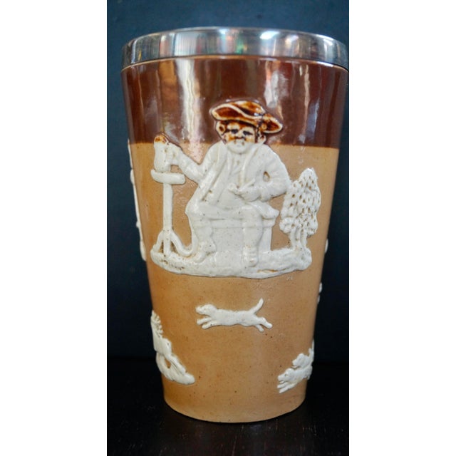 A royal doulton silver rimmed lambeth stoneware beaker, the harvest hunt range with a sterling silver rim, hallmark h.w....