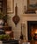 Charming vintage fireplace bellows featuring a warm wood body accented with dark metal details and a dimensional sailing...