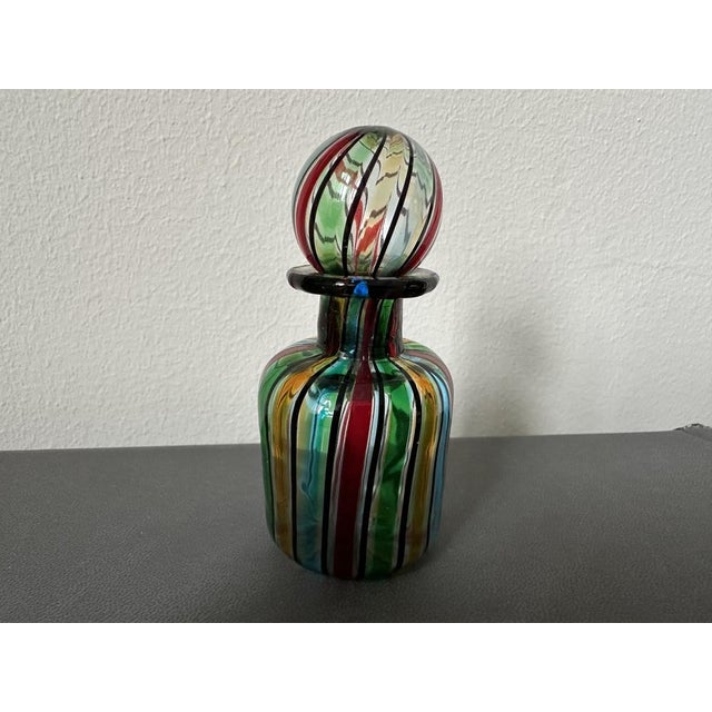 This delicate vintage perfume bottle, crafted from exquisite Murano glass in the 1950s, is a true testament to Italian...