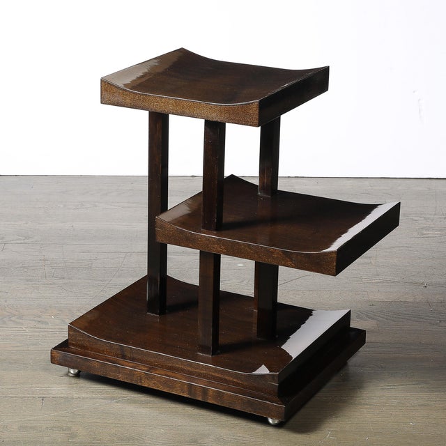 This Art Deco three-tier walnut side table, crafted in France circa 1935, epitomizes the refined elegance and geometric...