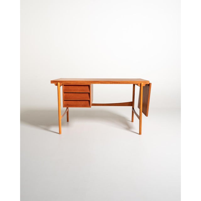 Teak frame with three drawers, extendable top with a 45 cm side extension, and tapered legs. Model "378" by Eric Johansson...