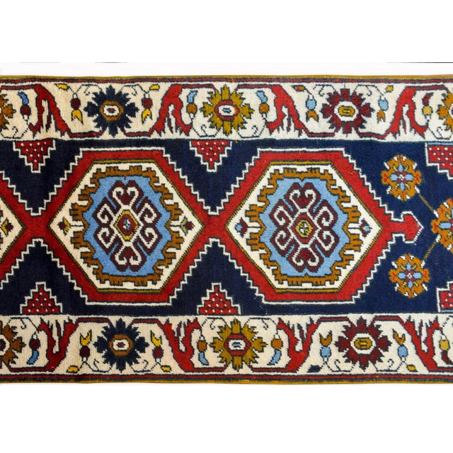 A wonderful 20th century Anatolian Turkish runner with four large boldly partnered medallions woven in brilliant indigo,...