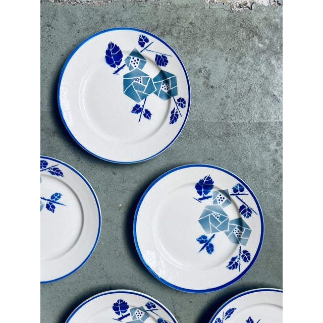 with their pretty stylized blue Art Deco flowers and border, these plates from the Keller et Guerin pottery in Lunéville...