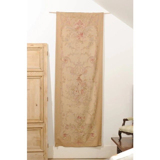 A French handwoven vertical tapestry from the 19th century, with soft muted colors and floral décor, lined and backed with...