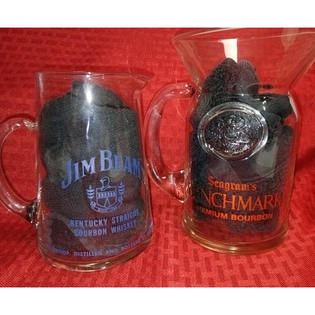 Nine Bourbon Whiskey Pitchers, All different. This is a nice collection to add to your man cave or to your dining room...