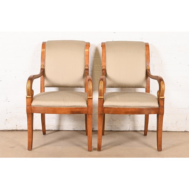 An outstanding pair of French Empire, Neoclassical, or Regency style armchairs, club chairs, or dining captain chairs By...