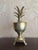 A stylish mid-century brass pineapple urn in the classic Hollywood Regency style. Features a warm polished brass finish,...