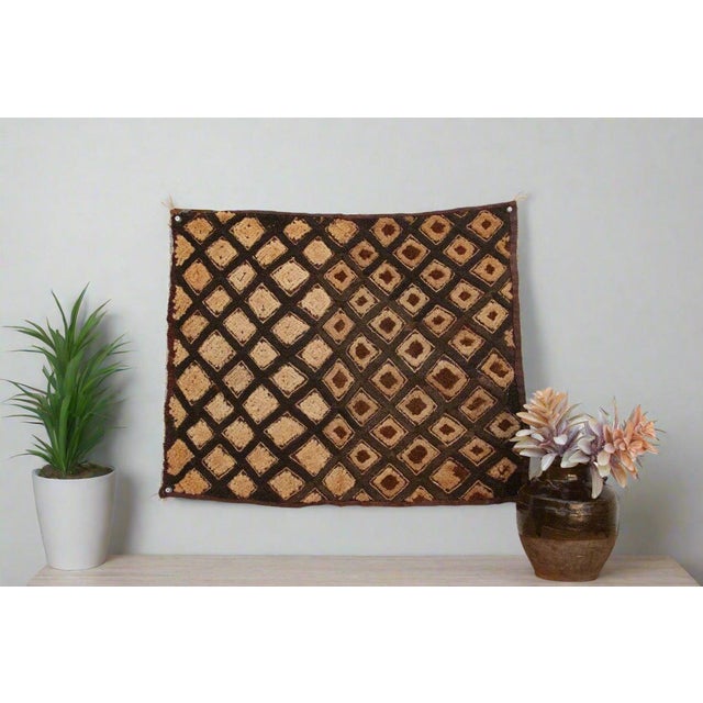 A captivating masterpiece of African textile art, this vintage Kuba cloth panel is a testament to the unparalleled...