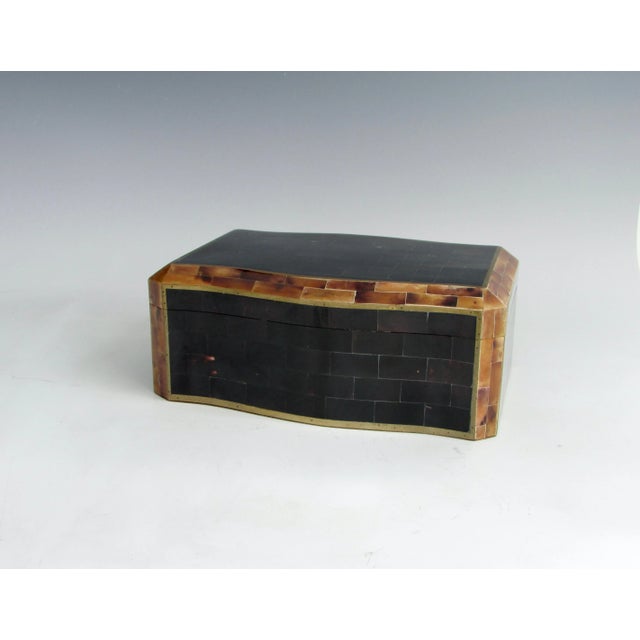 Elegant wood lined dresser box with hinged lid. Tessalated faux Horn exterior with brass trim. Interior is wood lined....