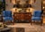 These are a matched pair of classic Regency style armchairs featuring exposed mahogany frames and rich blue velvet...