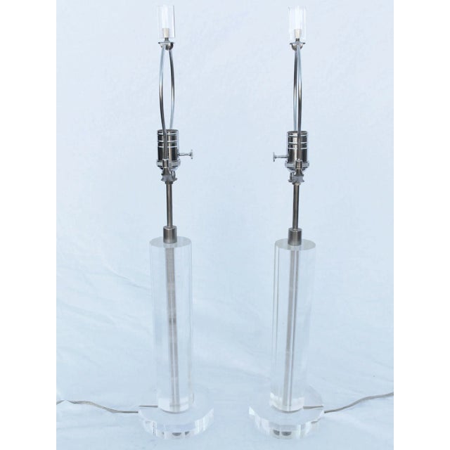 Shown is a vintage 1970's octagonal set of lucite lamps with lucite finials and new nickel finished 3 way switches. They...