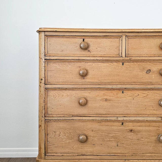 A warm antique pine chest of drawers crafted from solid pine, this piece carries a soft, timeworn patina with beautifully...