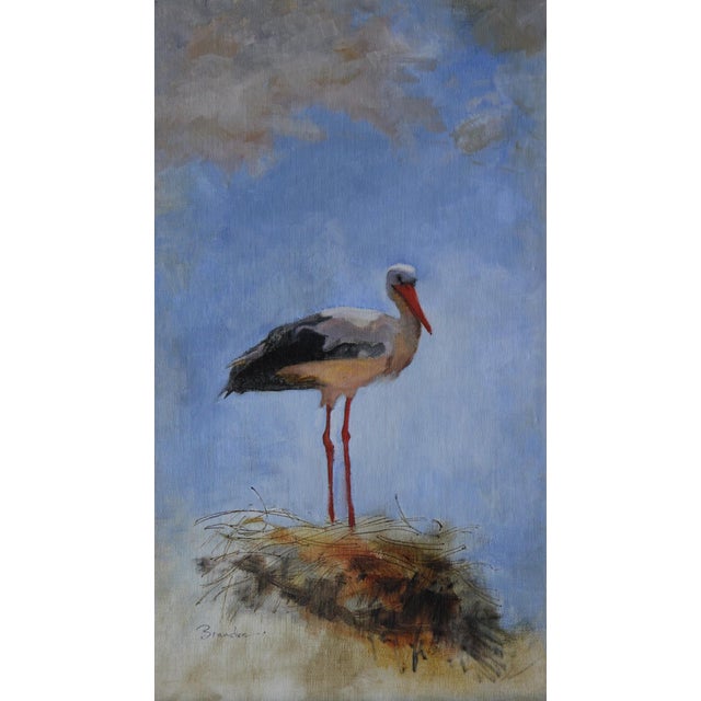 A solitary stork stands gracefully atop a nest, set against a serene sky that transitions from soft blues to gentle grays....