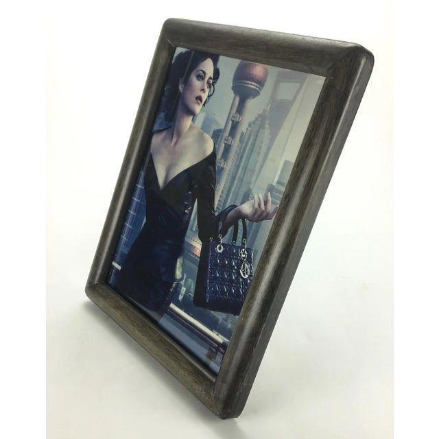 Nice exotic hardwood in a grayish color. The frame is glass protected and can sit vertically or horizontally. It can also...