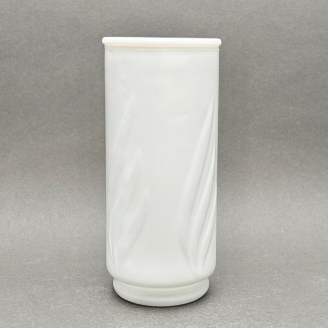 • Vintage milk glass flower vase with an elegant raised swirl design. • American-made, mid-century vintage. • Opaque white...
