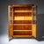 Biedermeier bookcase veneered in walnut with two doors, each approximately two-thirds glazed and paneled in the lower...
