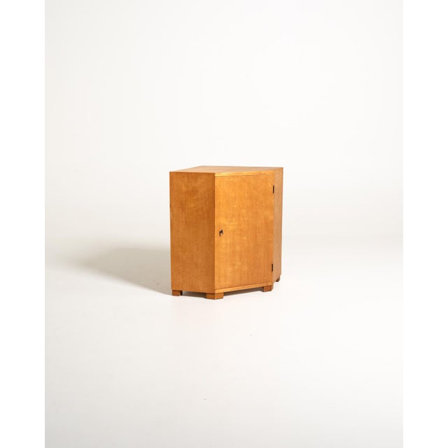 Scandinavian birch corner cabinet, mid-20th century, with a single lockable door, internal shelf, and a base with block...